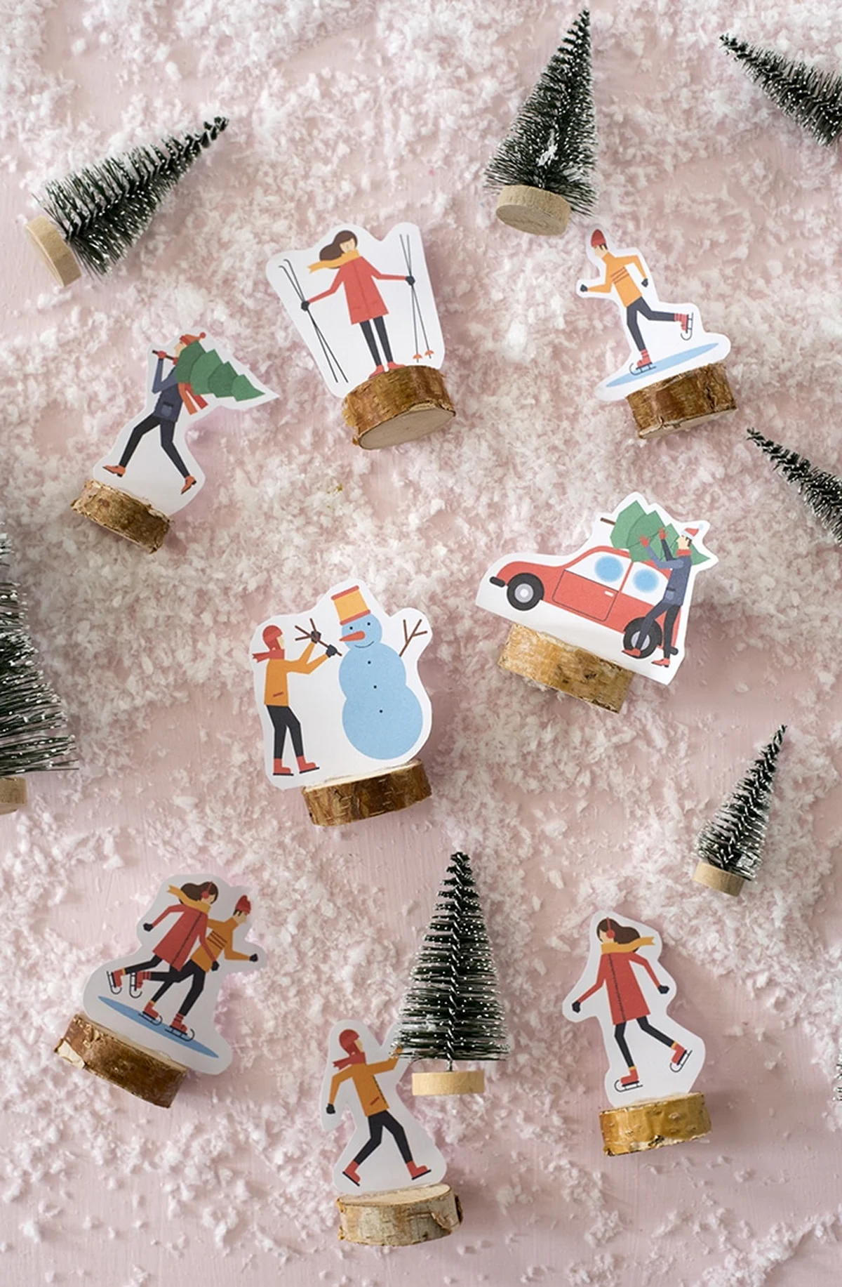 A festive flat-lay winter scene with paper cutout characters