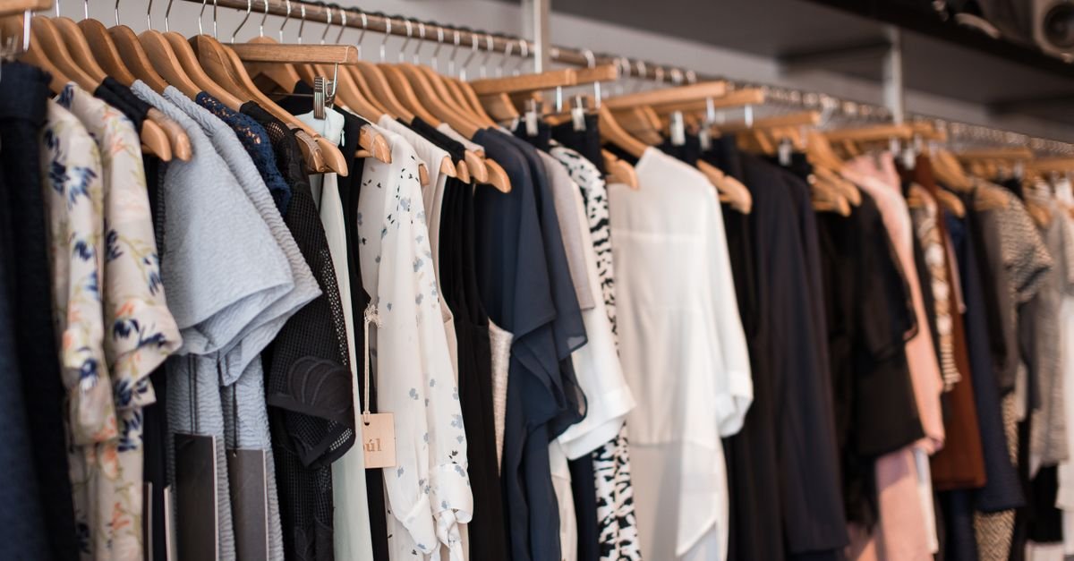 Colorful fall clothing on hangers in a boutique