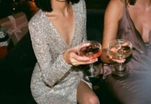 How Do You Style a Satin Blouse for a Holiday Party? Woman in a black satin blouse styled for a holiday party