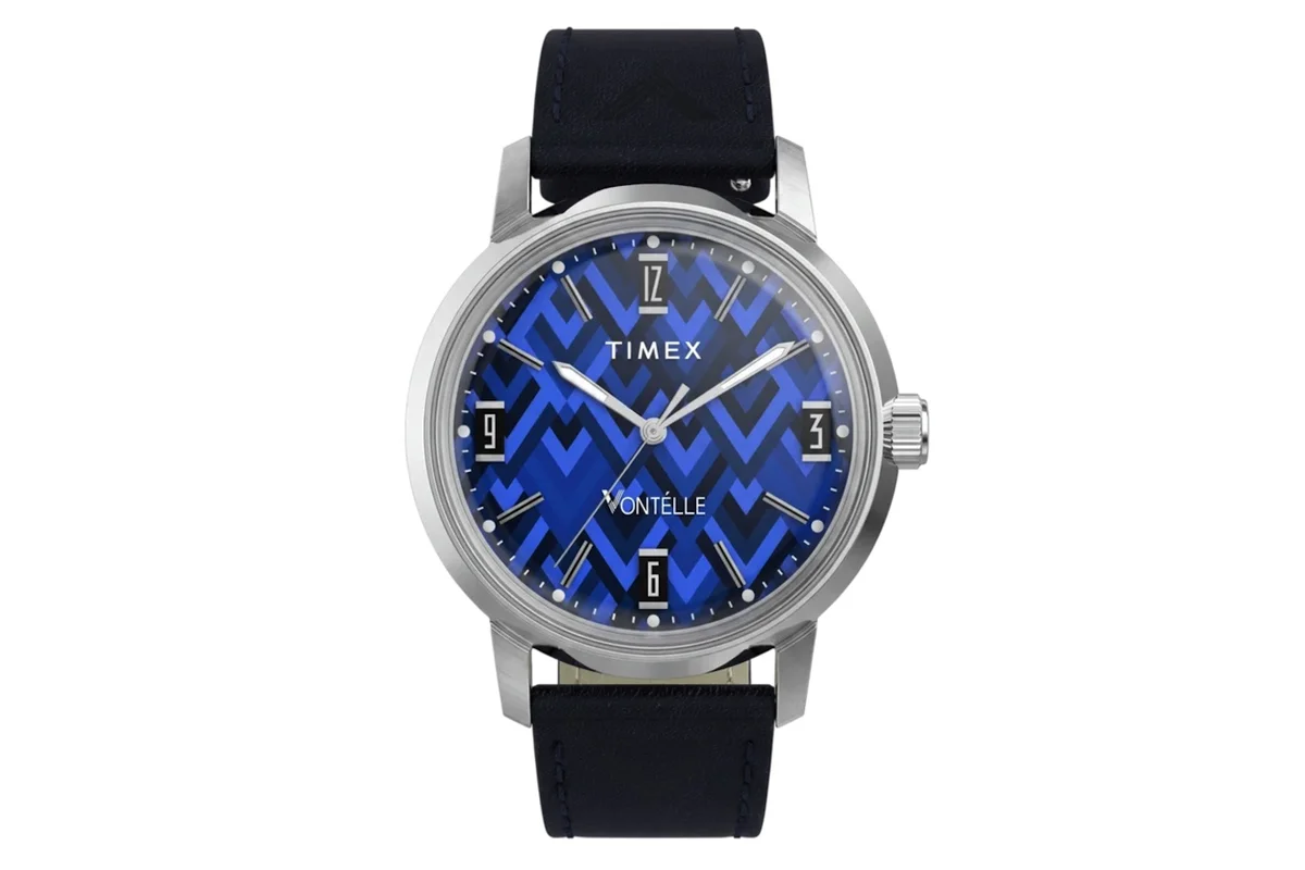 Silver Timex Marlin watch with blue chevron dial and navy leather strap